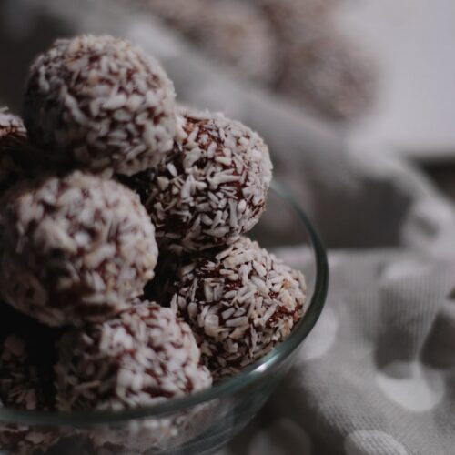 brown and white round fruits in clear glass bowl