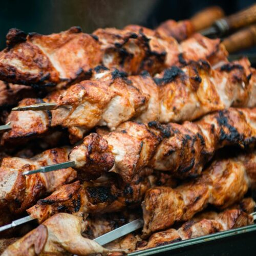 Juicy grilled shashlik skewers stacked outdoors, showcasing vibrant barbeque textures in Moldova.